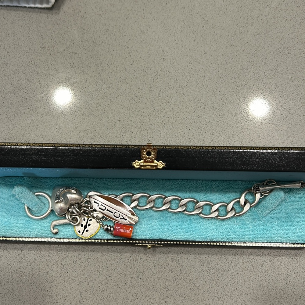 This chic Juicy Couture bracelet is in pristine condition. It has 5 charms